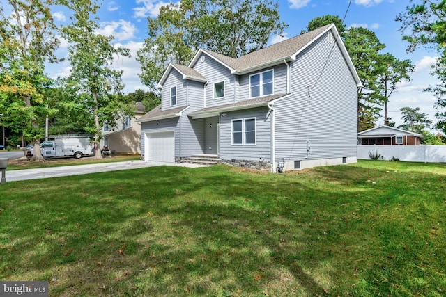 view of front of home with a front yard and a garage