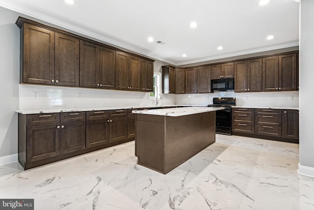 kitchen featuring dark brown cabinets, a center island, and black appliances