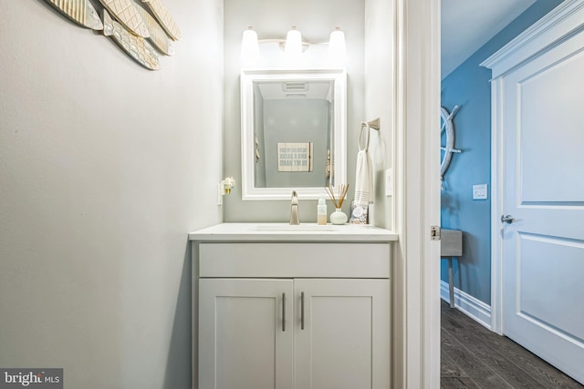 bathroom featuring hardwood / wood-style flooring and vanity