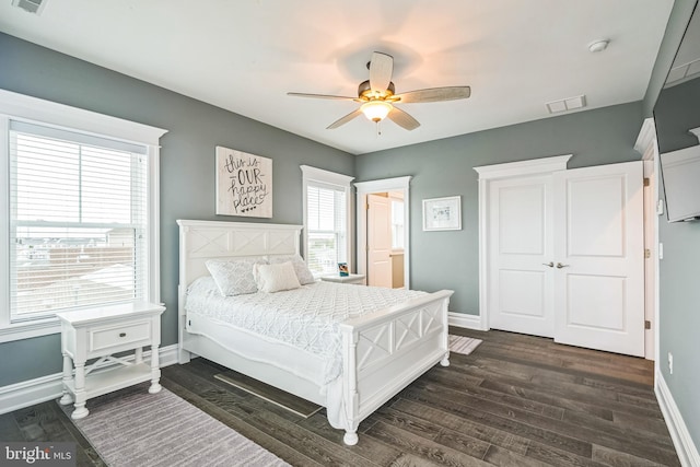 bedroom featuring ceiling fan and dark hardwood / wood-style floors