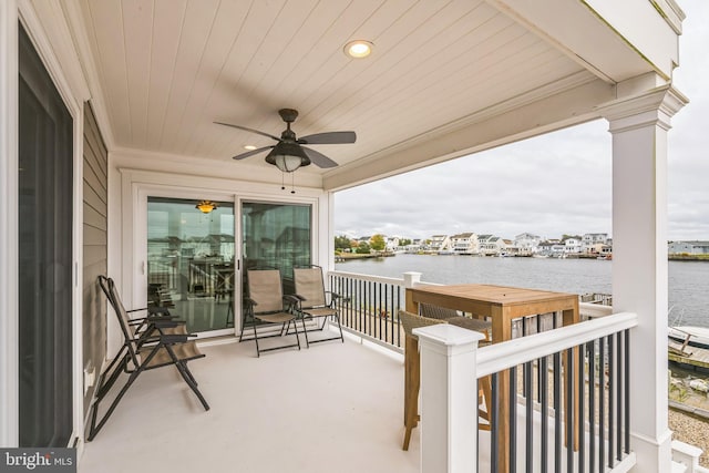 view of patio / terrace with a balcony, a water view, and ceiling fan