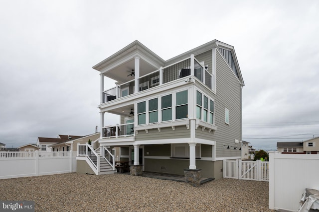 view of front facade featuring a balcony and ceiling fan