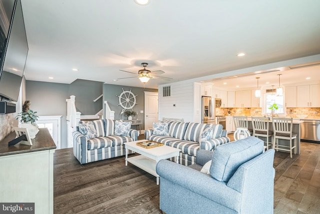 living room with ceiling fan and dark hardwood / wood-style floors