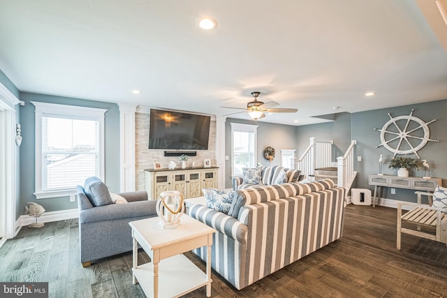 living room featuring a wealth of natural light, ceiling fan, and dark hardwood / wood-style floors