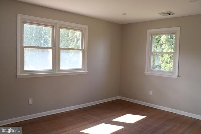 spare room featuring dark hardwood / wood-style floors