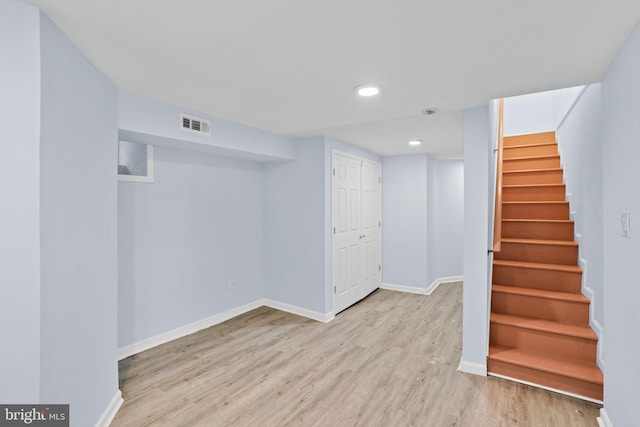 basement featuring light wood-type flooring