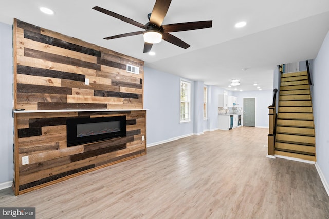 living room with light wood-type flooring and ceiling fan