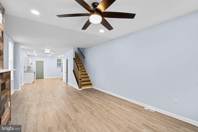 unfurnished living room featuring light wood-type flooring and ceiling fan