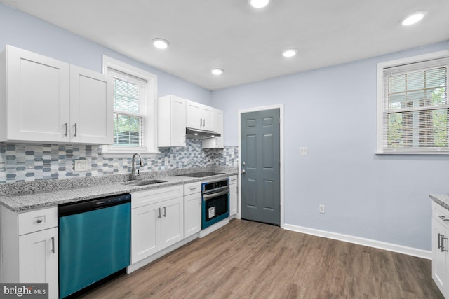 kitchen with light stone counters, dark hardwood / wood-style floors, sink, white cabinets, and stainless steel appliances