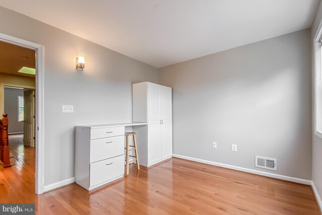 interior space featuring built in desk and light hardwood / wood-style floors