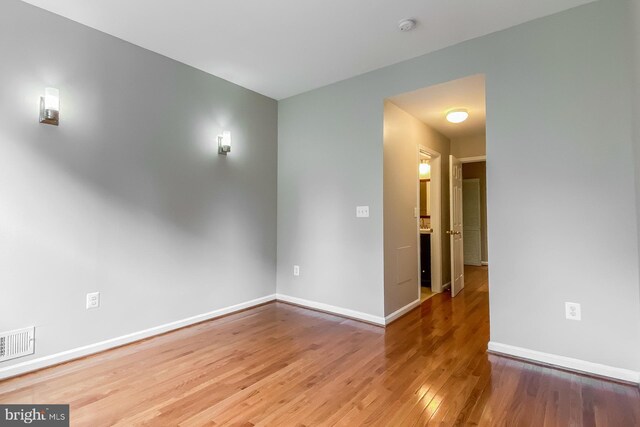 spare room with hardwood / wood-style flooring