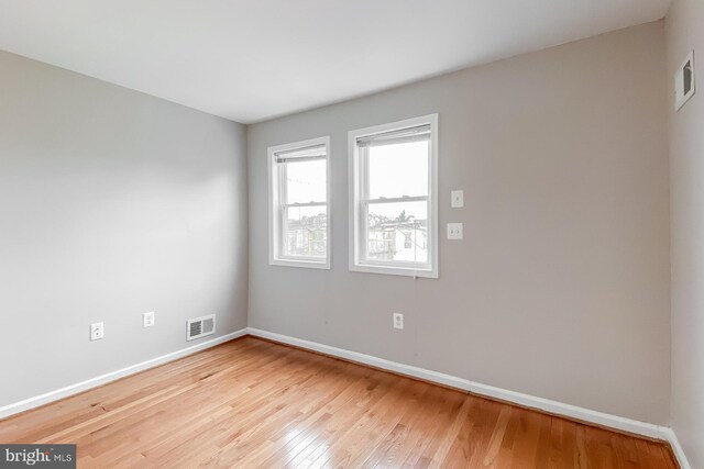 unfurnished room with light wood-type flooring