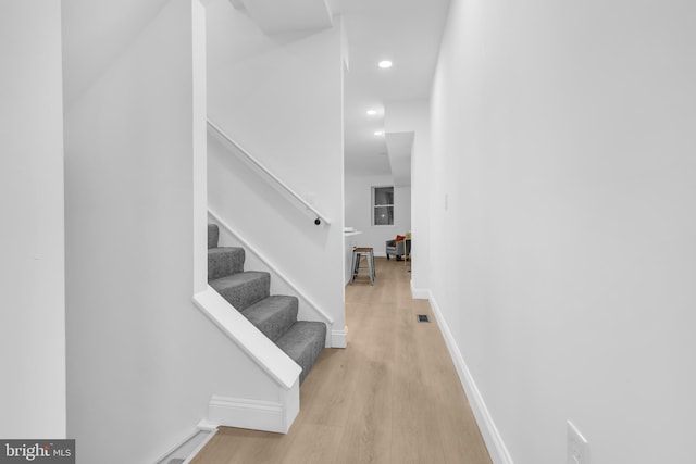 stairway featuring hardwood / wood-style flooring