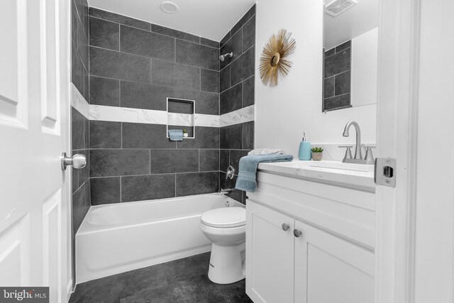 full bathroom with vanity, toilet, and tiled shower / bath