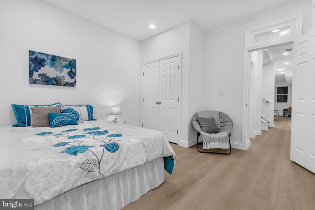 bedroom featuring light hardwood / wood-style flooring and a closet