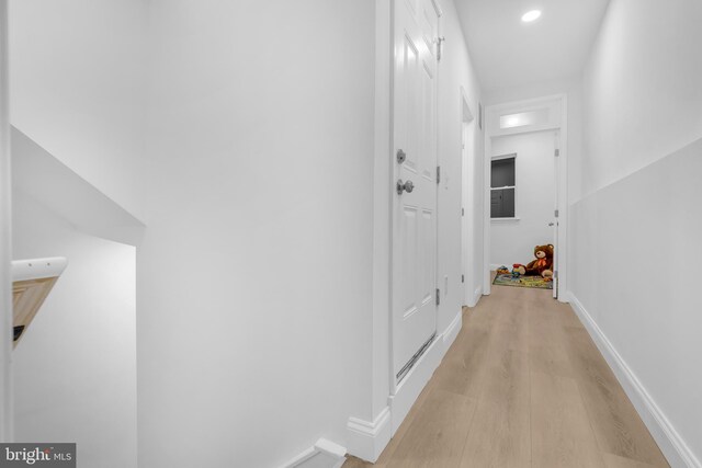 corridor with light hardwood / wood-style flooring