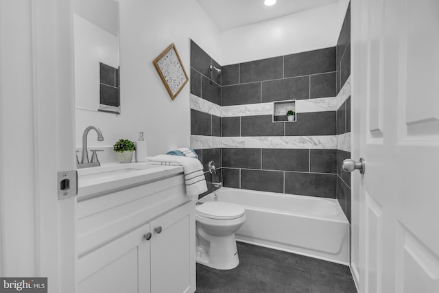 full bathroom with vanity, tiled shower / bath combo, and toilet