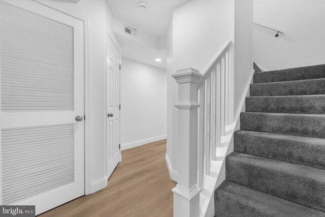 stairway with hardwood / wood-style floors