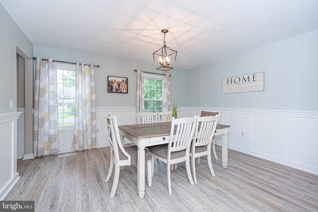 dining room featuring an inviting chandelier and light hardwood / wood-style floors