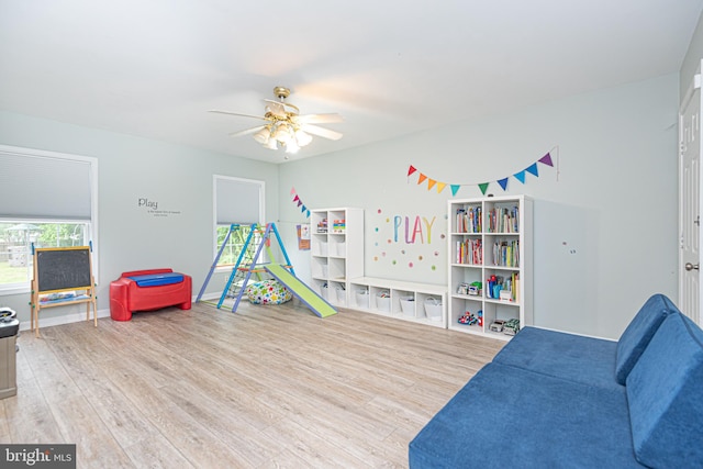 recreation room with ceiling fan and hardwood / wood-style flooring