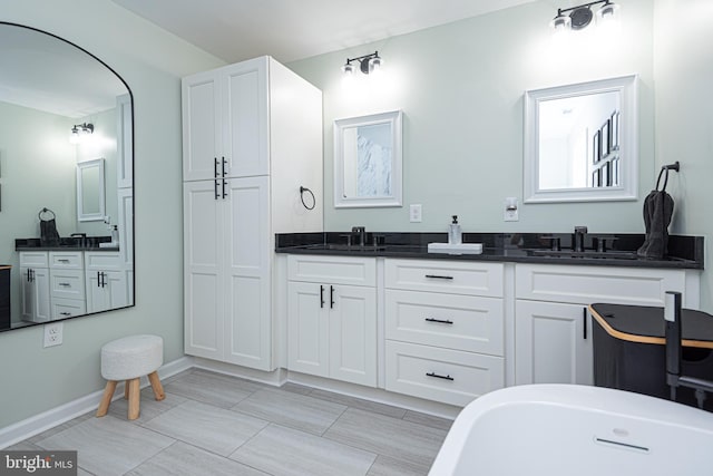 bathroom with a tub to relax in and vanity