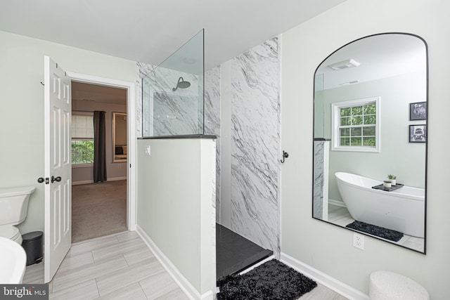 bathroom with shower with separate bathtub and toilet