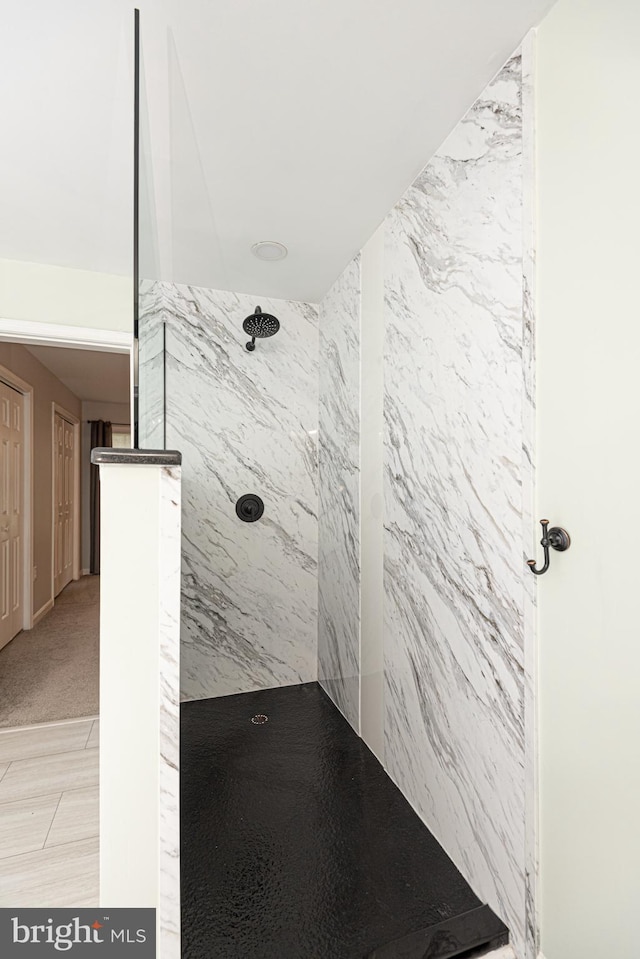 bathroom with a tile shower