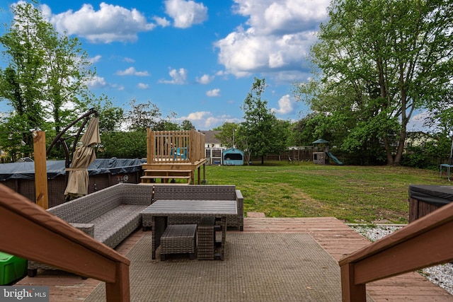 view of patio / terrace featuring a wooden deck, an outdoor hangout area, and a playground