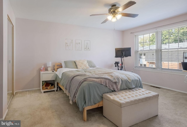 bedroom with light carpet and ceiling fan