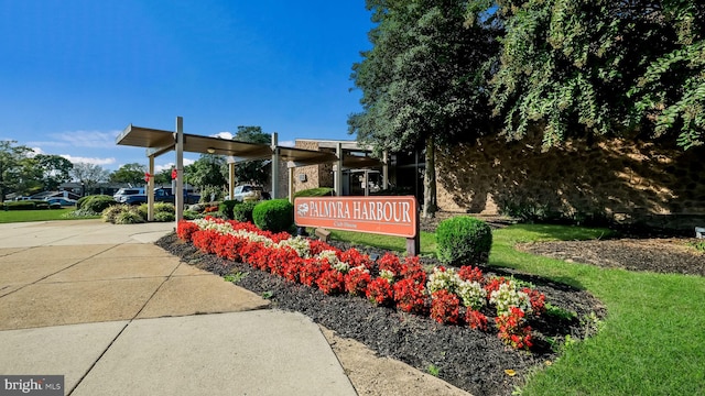 community sign featuring a lawn