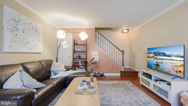 living room with hardwood / wood-style flooring and crown molding