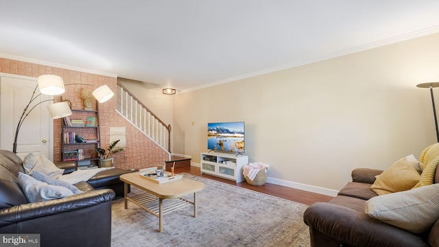 living room with wood-type flooring and ornamental molding