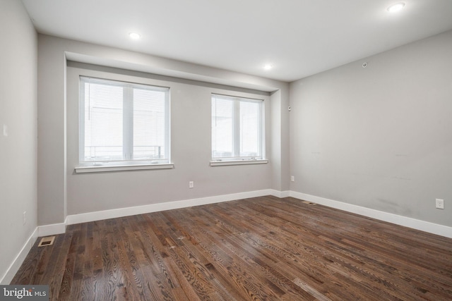 spare room with dark hardwood / wood-style flooring