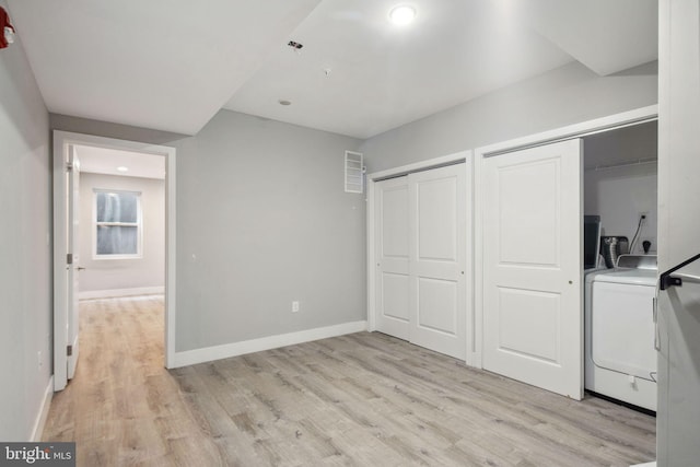 interior space with light hardwood / wood-style floors and hookup for an electric dryer