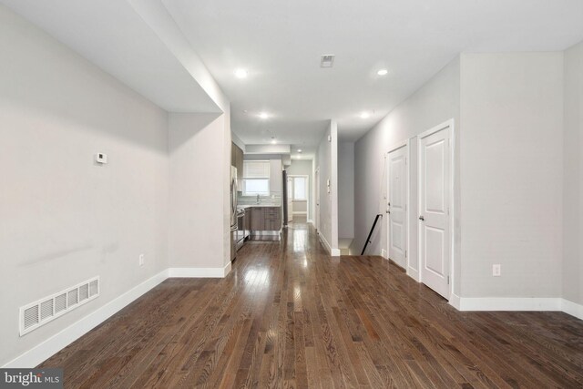 empty room featuring sink and dark wood-type flooring