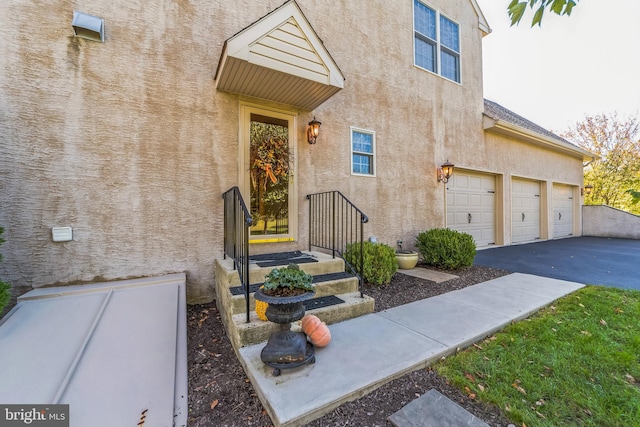 view of exterior entry with a garage