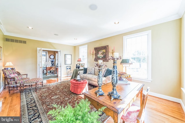 living room featuring ornamental molding and light wood-type flooring