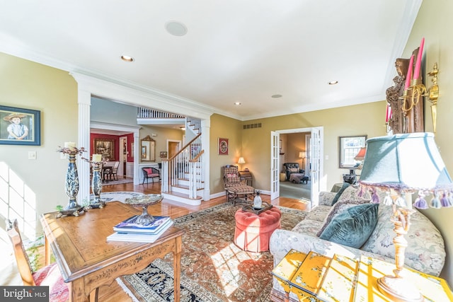 living room with french doors, crown molding, and hardwood / wood-style floors