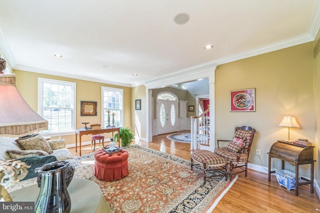 living room featuring ornamental molding and light hardwood / wood-style flooring