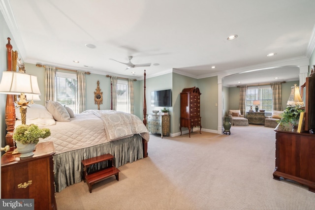 bedroom with ceiling fan, ornamental molding, and multiple windows