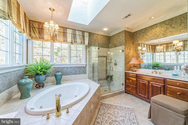 bathroom with vanity, a skylight, plenty of natural light, and separate shower and tub