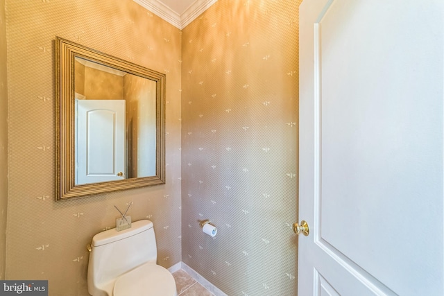 bathroom featuring toilet, ornamental molding, and tile patterned floors