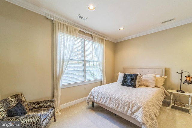 bedroom with crown molding and light colored carpet