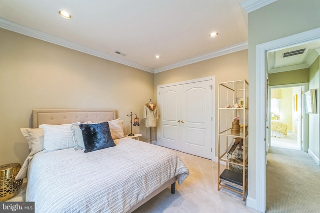 carpeted bedroom featuring ornamental molding and a closet