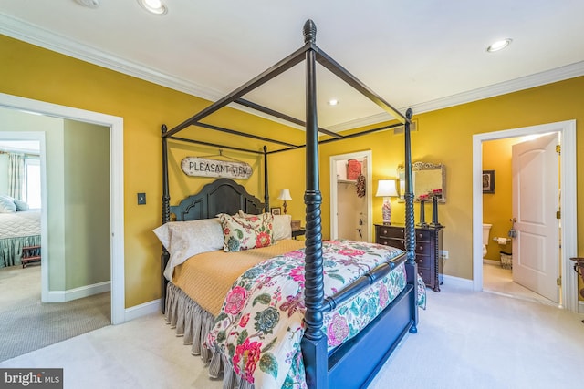 carpeted bedroom with connected bathroom and ornamental molding