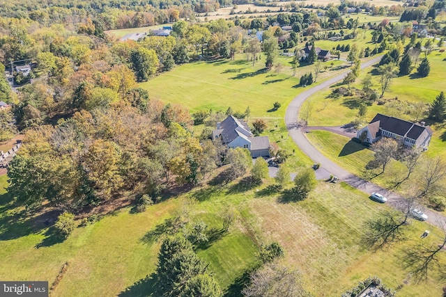 birds eye view of property with a rural view