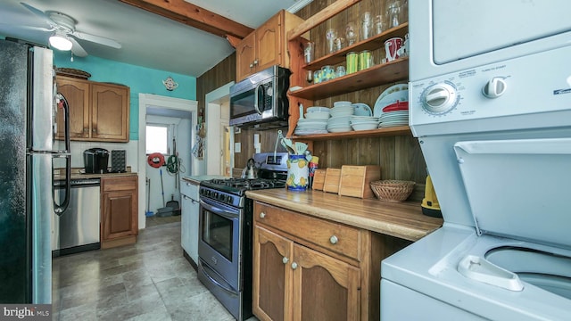 kitchen with stacked washer / dryer, ceiling fan, and stainless steel appliances