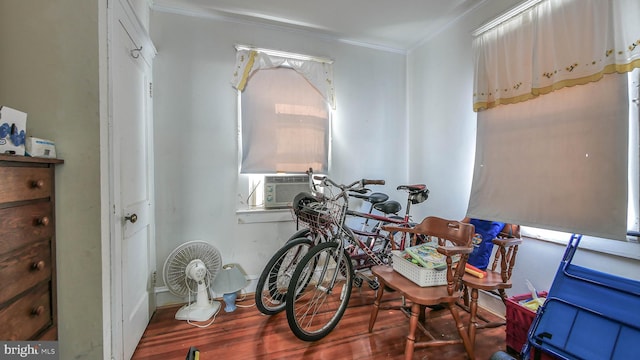 miscellaneous room with cooling unit, hardwood / wood-style flooring, and crown molding