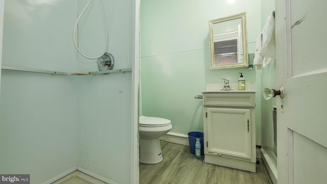 bathroom with hardwood / wood-style floors, vanity, and toilet