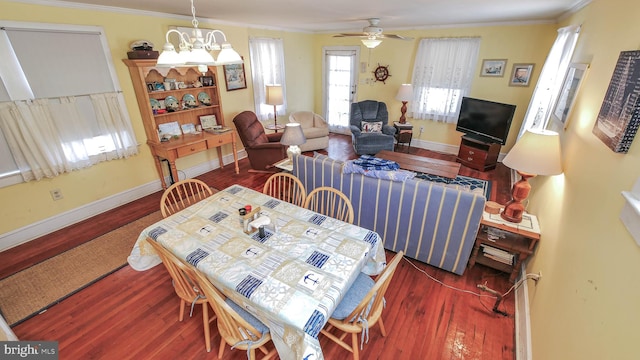 dining room with ornamental molding, ceiling fan, and dark wood-type flooring